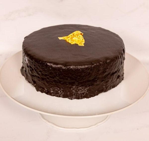 Chocolate Sacher Cake on a cake stand