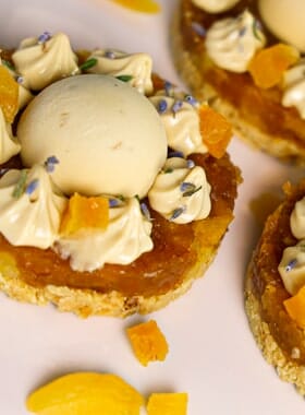 Cream Tart on serving tray with sprinkles dried lemon and apricot