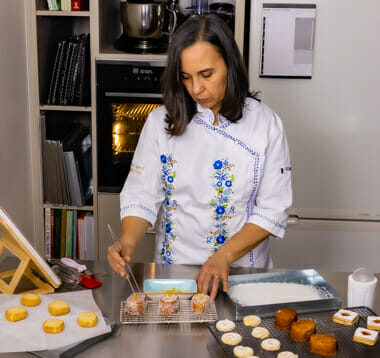 Silvina adding final decoration to one of her petit four desserts