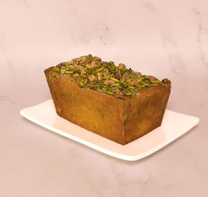 Coffee, pistachio and walnut pound cake on whit plate